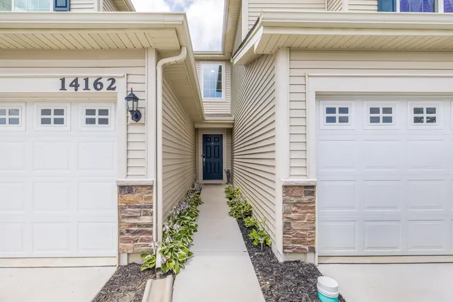 a view of a house with potted plants