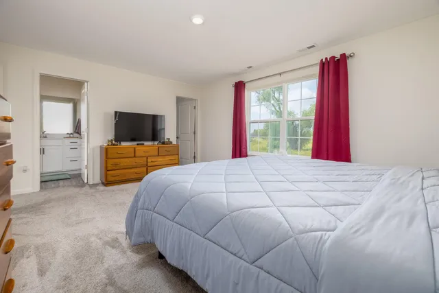 a bedroom with a bed and window