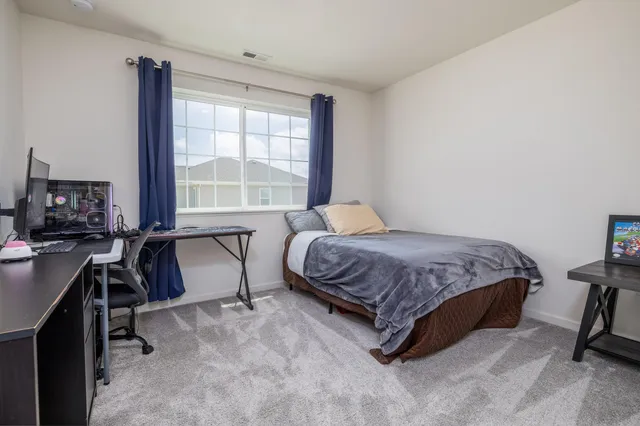 a bedroom with a bed and a desk