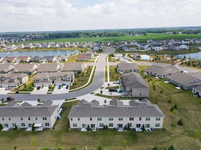 an aerial view of residential houses with outdoor space