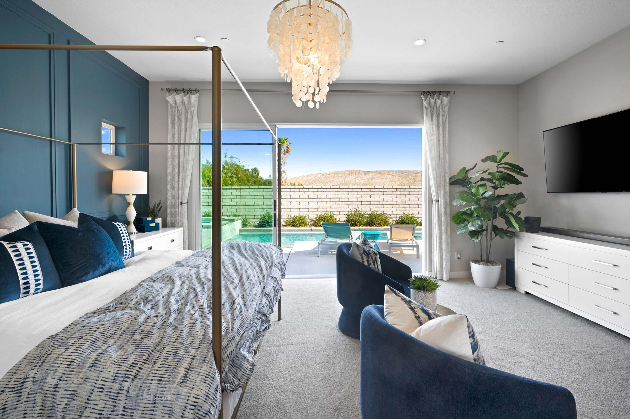 2 Iridium Way Rancho Mirage, CA 92270 - Photo 18 of 55 a living room with furniture a chandelier and a large window