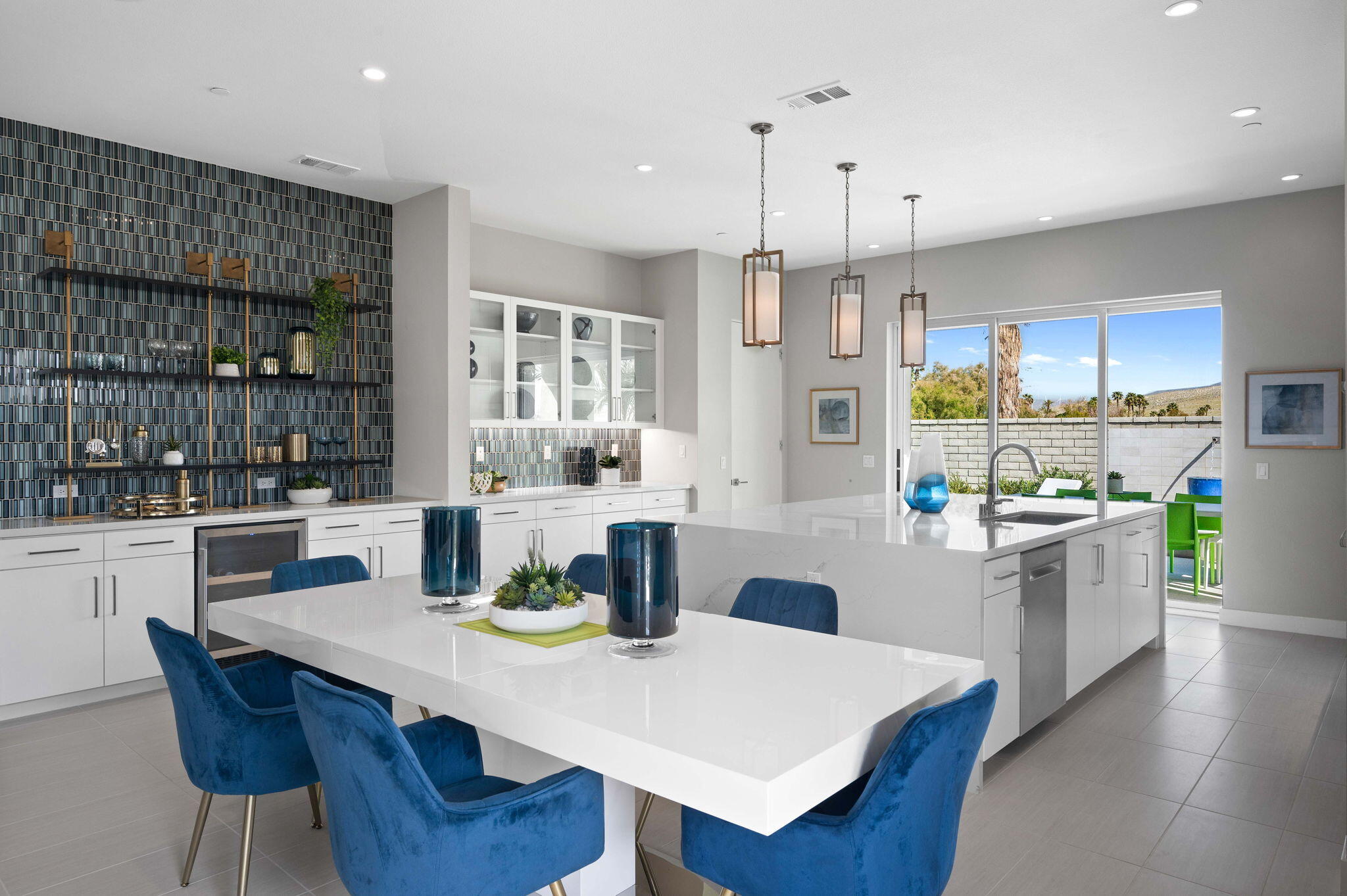 2 Iridium Way Rancho Mirage, CA 92270 - Photo 9 of 55 a kitchen with stainless steel appliances kitchen island granite countertop a table chairs and a refrigerator