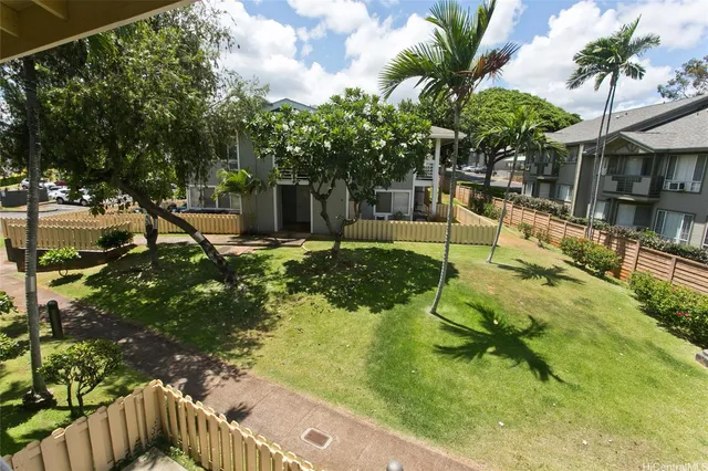 a view of backyard with a table and chairs and potted plants