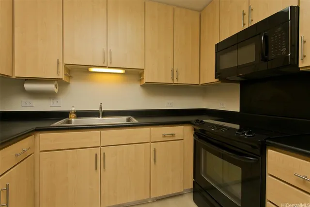 a kitchen with stainless steel appliances granite countertop a sink stove and microwave