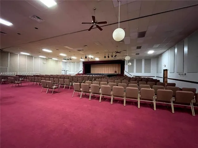 a living room with lots of furniture and a large window