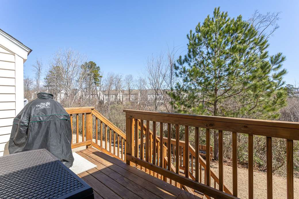 8206 Marvino Lane Raleigh, NC 27613 - Photo 24 of 30 Deck allows additional space for grilling! Stairs lead down to patio and back yard! Deck