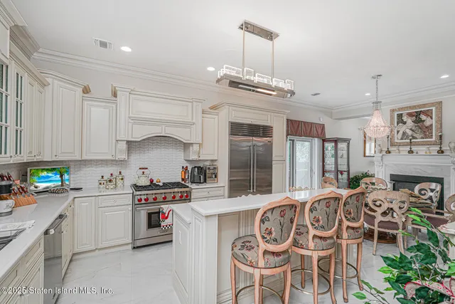 a kitchen with stainless steel appliances granite countertop a sink a stove and cabinets
