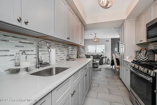 a bedroom with a bed a flat screen tv and a large window