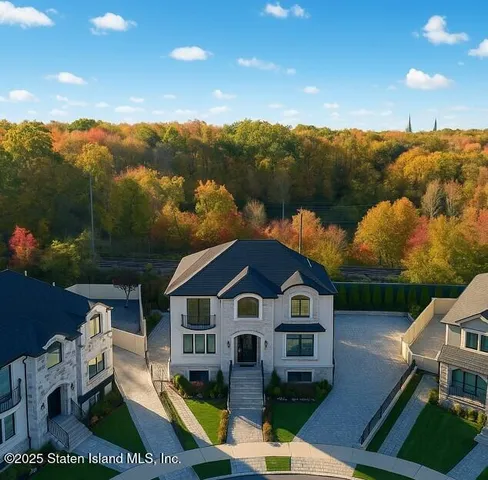an aerial view of a house with swimming pool and mountains