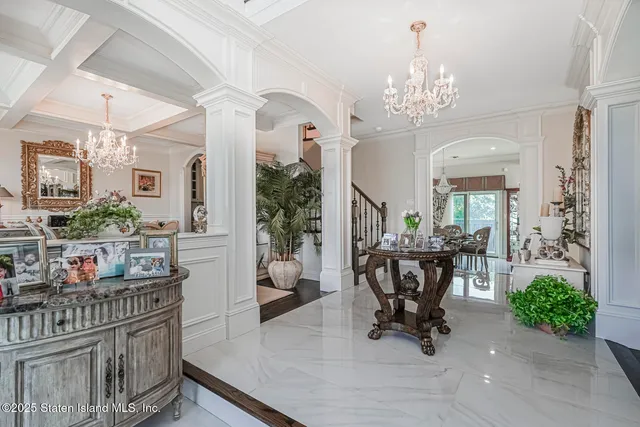 a view of a dining room with furniture and a chandelier