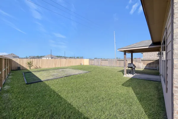a view of a house with a yard and sitting area