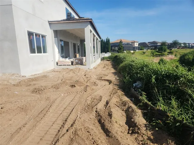 a view of a house with a yard and pathway
