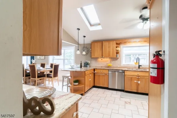 a kitchen with stainless steel appliances granite countertop a sink and cabinets