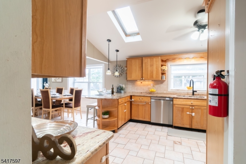 8 Dahlia Road Somerset, NJ 08873 - Photo 12 of 41 a kitchen with stainless steel appliances granite countertop a sink and cabinets