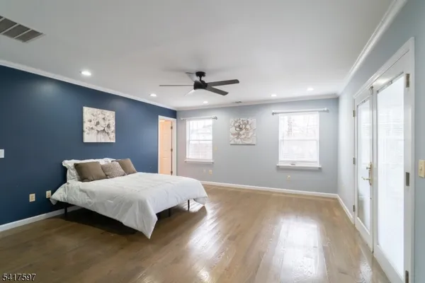 a bedroom with a bed and a large window