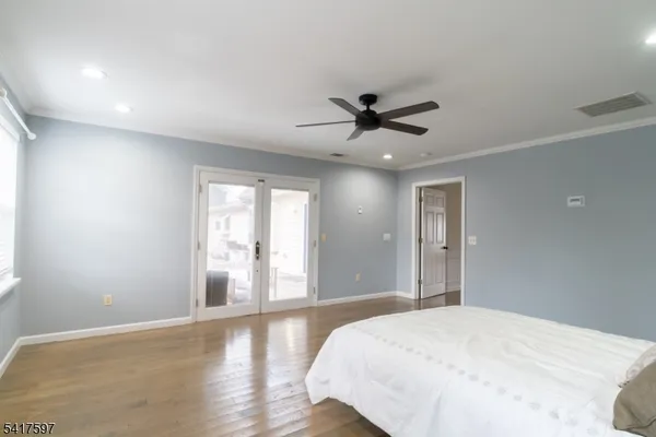 a bedroom with a large bed and a window