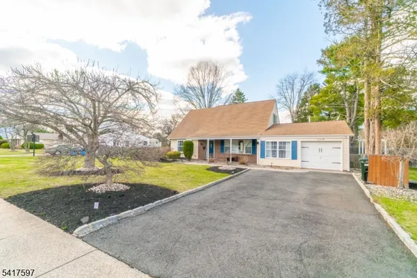 a front view of a house with yard and green space