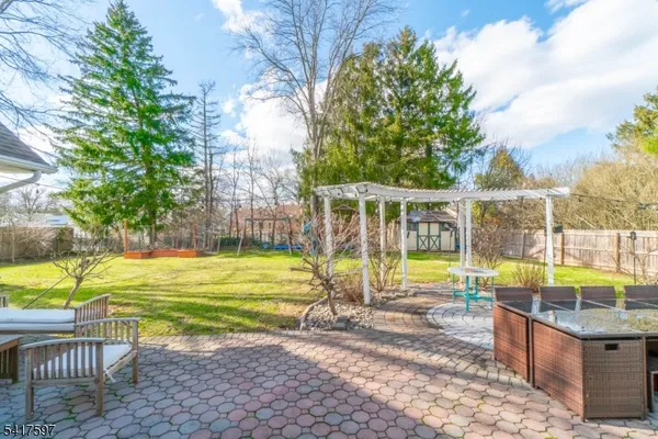 a view of a swimming pool with a patio and a yard