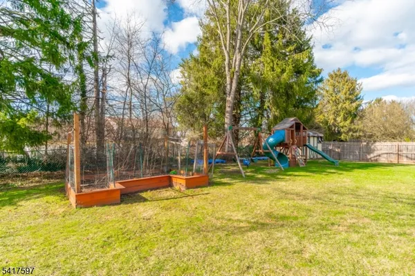 a view of a playground with a slide and a small yard