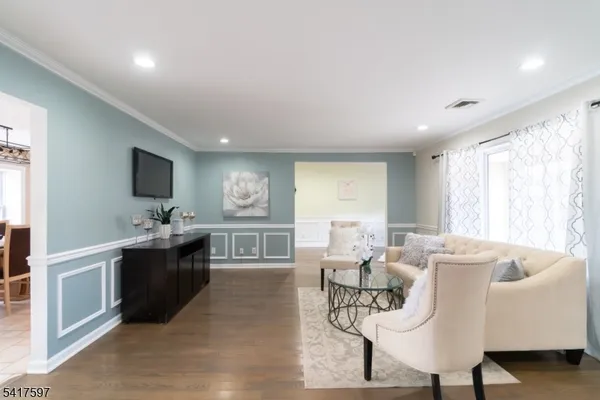 a living room with furniture windows and a flat screen tv