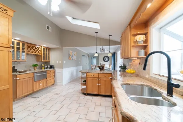 a kitchen with stainless steel appliances granite countertop a sink and stove