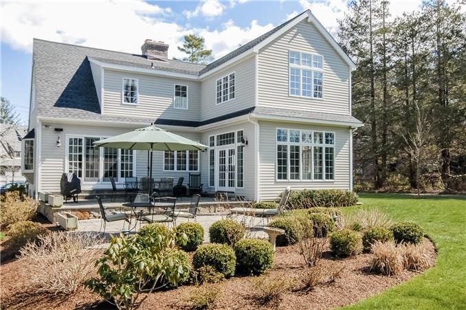 9 Ivy Hill Road Ridgefield, CT 06877 - Photo 1 of 1 a front view of a house with a yard table and chairs