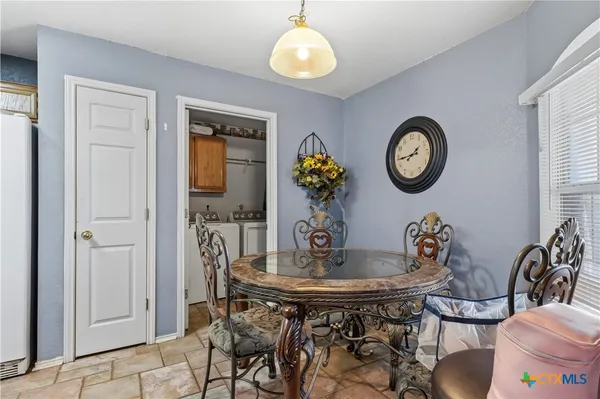 a view of a dining room with furniture and a chandelier