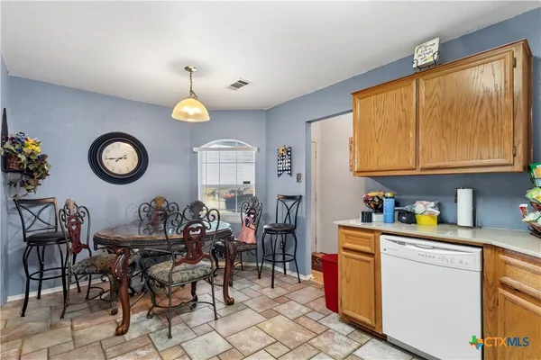 a kitchen with a table and chairs in it