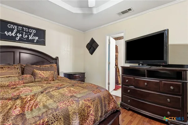 a bedroom with a bed and a flat screen tv