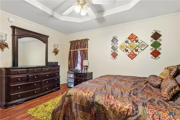 a bedroom with a bed and a chandelier