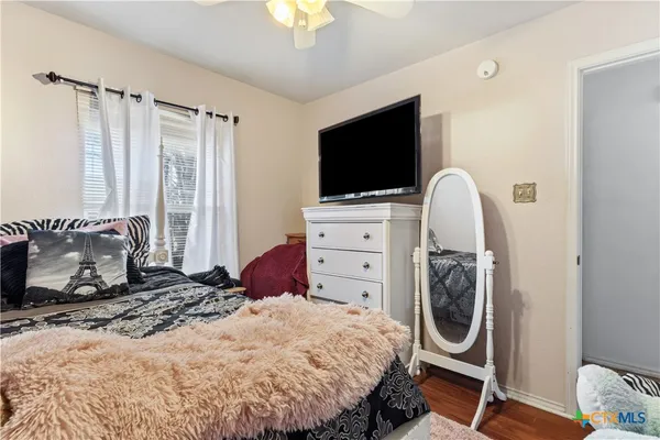a bedroom with a bed and a flat screen tv