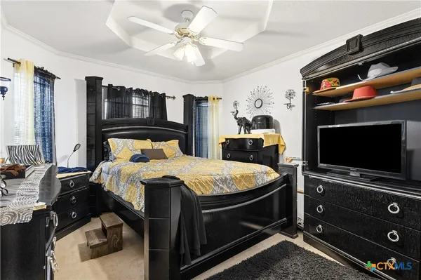 a bed room with a bed and a television