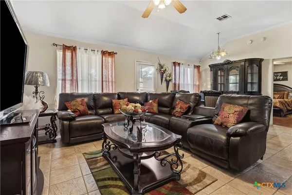 a living room with furniture and a chandelier