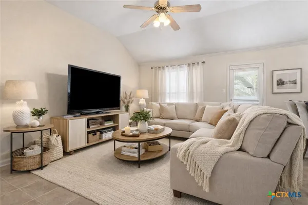 a living room with furniture and a flat screen tv
