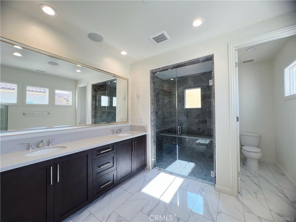 185 Bryce Run Lake Forest, CA 92630 - Photo 20 of 34 a bathroom with a sink a toilet and a large mirror