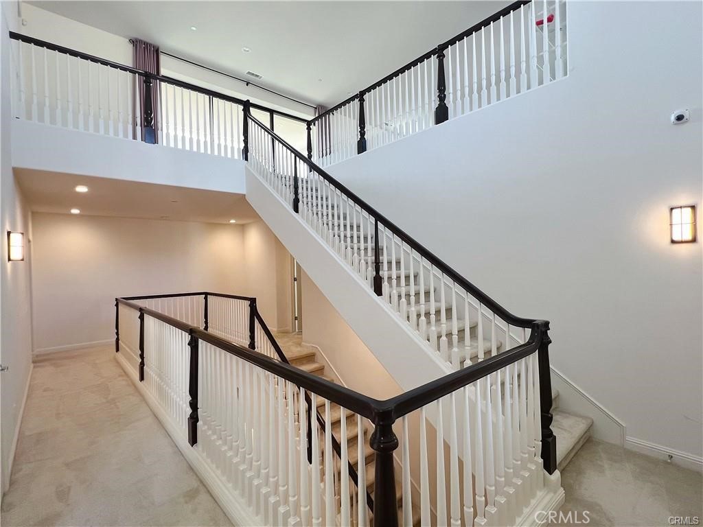 185 Bryce Run Lake Forest, CA 92630 - Photo 22 of 34 a view of staircase with lots of frames on wall and a window