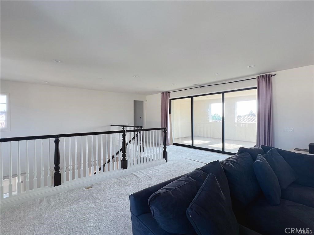 185 Bryce Run Lake Forest, CA 92630 - Photo 31 of 34 a living room with a bed next to a large window