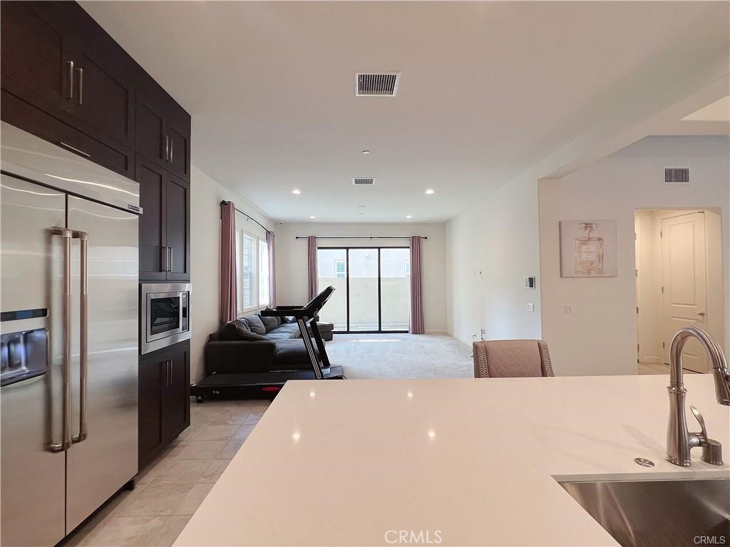 185 Bryce Run Lake Forest, CA 92630 - Photo 8 of 34 a large bedroom with bed or furniture and a refrigerator