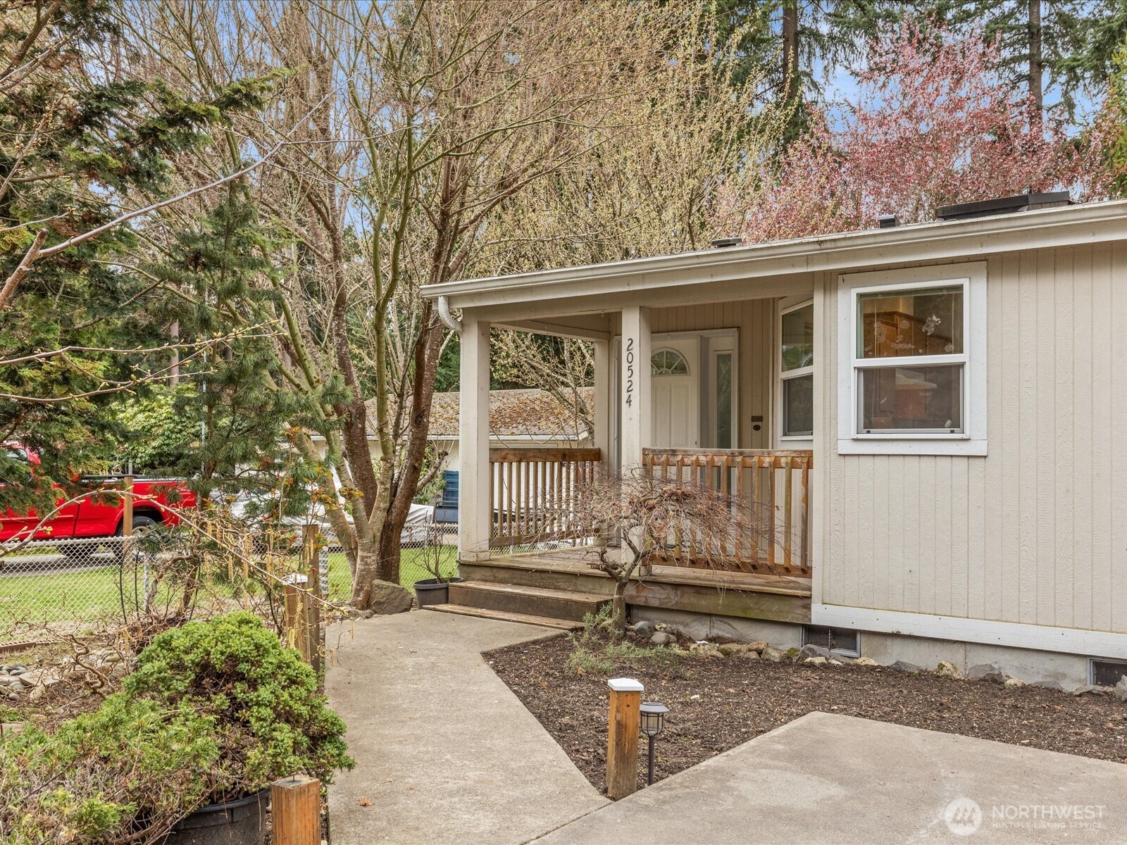 a front view of a house with a tree