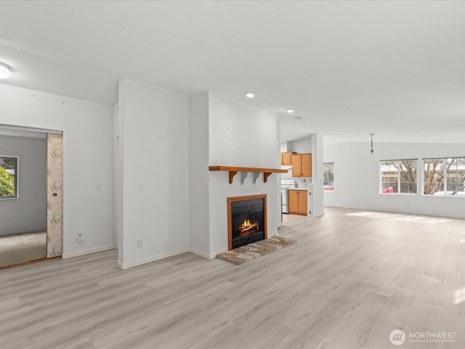 20524 32nd Drive Southeast Bothell, WA 98012 - Photo 9 of 39 a view of an empty room with wooden floor fireplace and a window