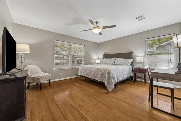 a kitchen with stainless steel appliances granite countertop a refrigerator a sink dishwasher a oven with wooden cabinets and floor