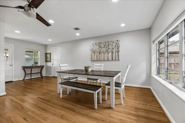 a view of a dining room with furniture window and wooden floor