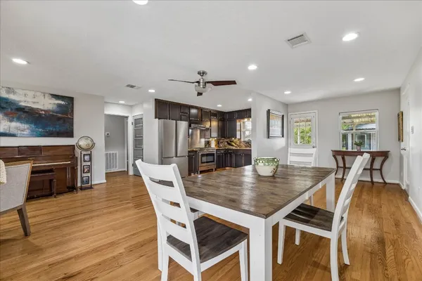 a view of a dining room with furniture and wooden floor