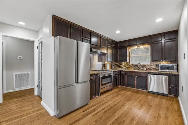 a view of a dining room with furniture and wooden floor