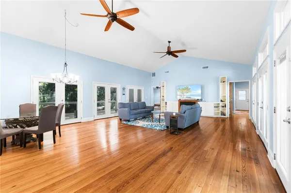 a living room with furniture and a wooden floor