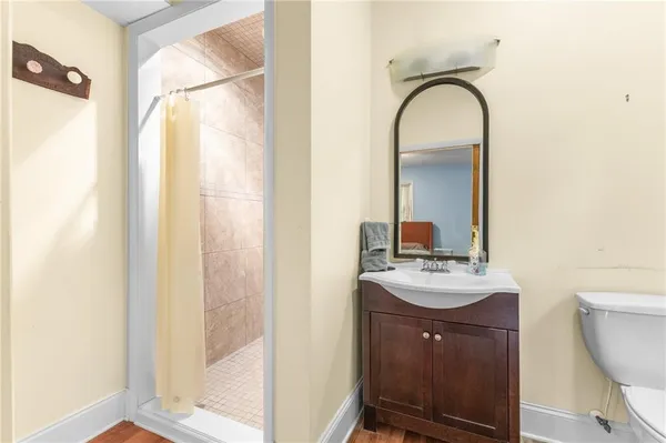 a bathroom with a sink a toilet and a mirror