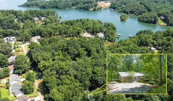 aerial view of a house with outdoor space and lake view