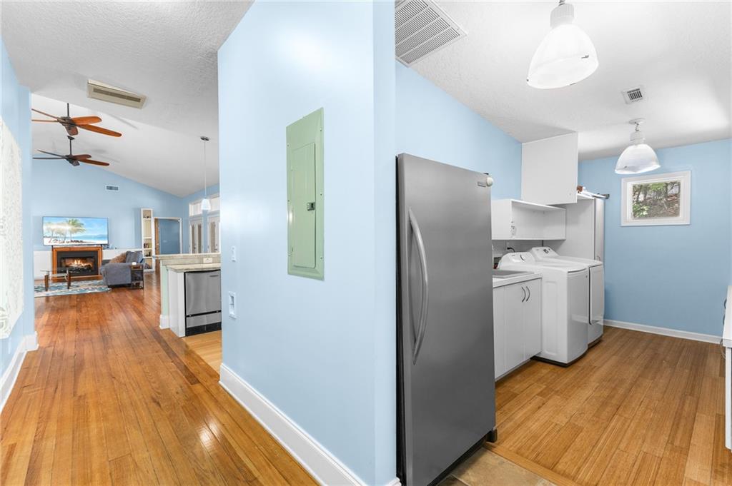 6567 Tahiti Way Flowery Branch, GA 30542 - Photo 27 of 36 a kitchen with a refrigerator and a stove