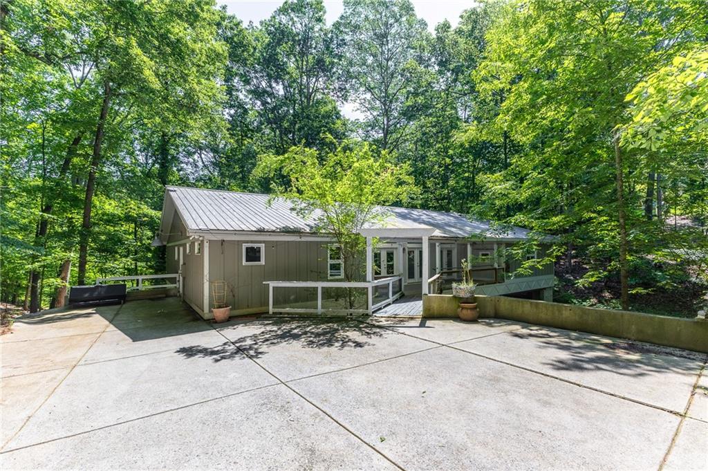 6567 Tahiti Way Flowery Branch, GA 30542 - Photo 6 of 36 a view of a house with backyard garden and a tree