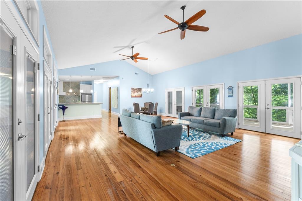 6567 Tahiti Way Flowery Branch, GA 30542 - Photo 8 of 36 a living room with furniture and wooden floor